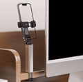 Tekvyn FoldGrip phone holder clamped to a desk holding a phone at eye level