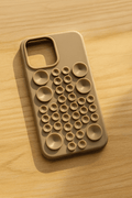 Silicone Pop It iPhone case by Tekvynstore featuring colorful, playful pop-it buttons on a clear protective phone cover.